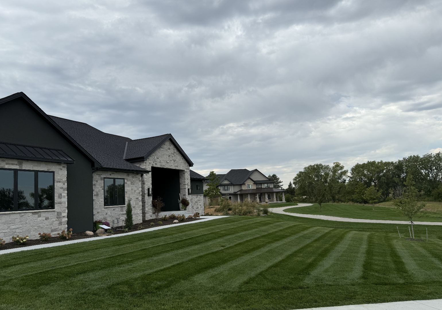 Professional landscaper mowing a beautiful suburban lawn